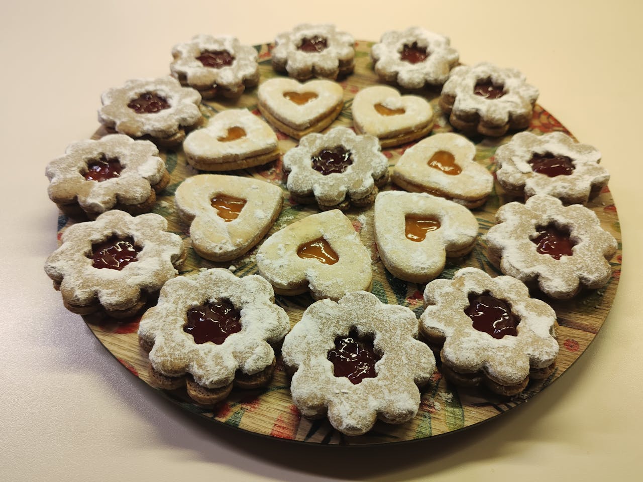 A tempting platter of homemade jam-filled Linzer cookies, perfect for festive gatherings.