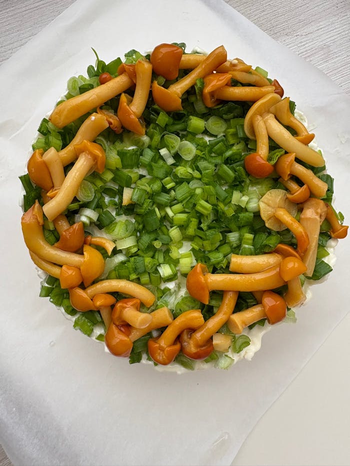 Top view of a fresh salad with vibrant mushrooms and chopped green onions.
